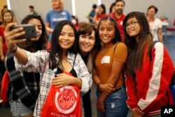 Rep. Jacky Rosen, D-Nev., center, poses for a selfie with high school students at an event put on by the Asian Community Development Council in Las Vegas, Sept. 29, 2018. In the high-stakes race for Senate in Nevada, Rosen is taking on one of the biggest names in GOP politics by painting Sen. Dean Heller as someone without firm principles.