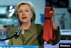 FILE - U.S. Democratic presidential nominee Hillary Clinton holds up a Donald Trump-brand tie made in China during a stop at a local tie company in Denver, Colorado, Aug. 3, 2016.