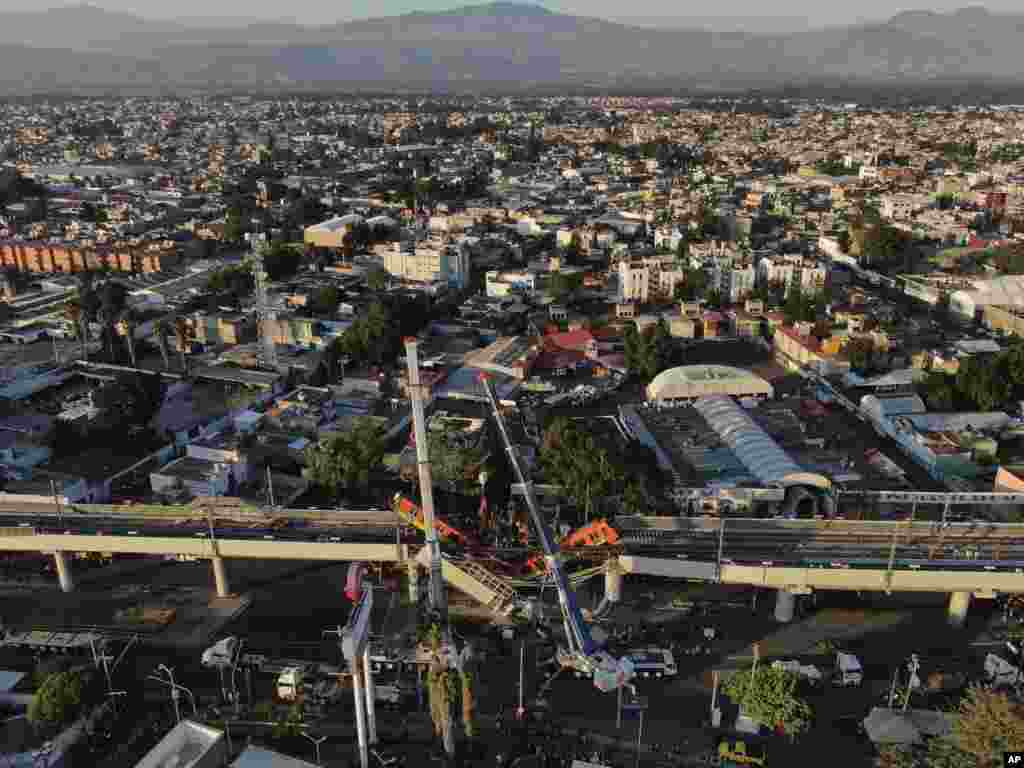 An aerial view of subway cars dangle at an angle from a collapsed elevated section of the metro, in Mexico City, &nbsp;killing at least 23 people and injuring at least 79.