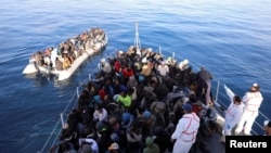 Migrants are seen in a rubber dinghy as they are rescued by Libyan coast guards in the Mediterranean Sea off the coast of Libya, Jan. 15, 2018. 