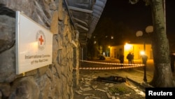 The body of a victim killed by recent shelling lies near the Red Cross office in Donetsk, eastern Ukraine, Oct. 2, 2014. 
