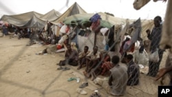FILE - Ethiopian migrants are seen in a make-shift camp near the western Yemeni town of Haradh in a March 21, 2012, photo. Djiboutian authorities confirm at least 24 migrants have died in recent weeks due to deportation conditions they faced in Yemen.