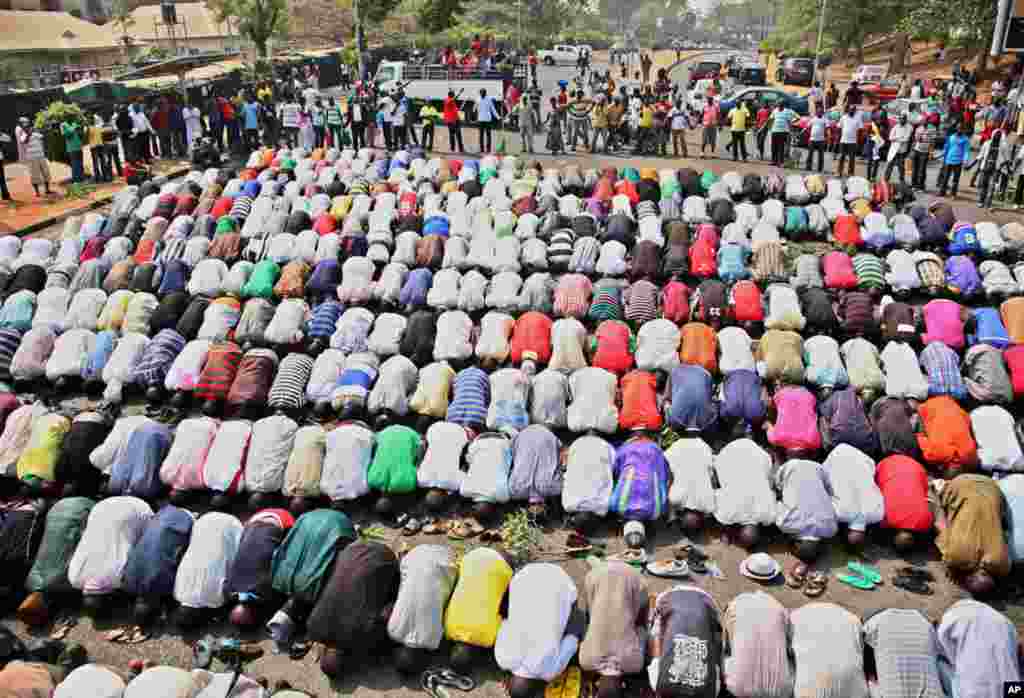 Muslims pray while Christians form a protective human chain around them, during protests in Abuja. (Reuters)