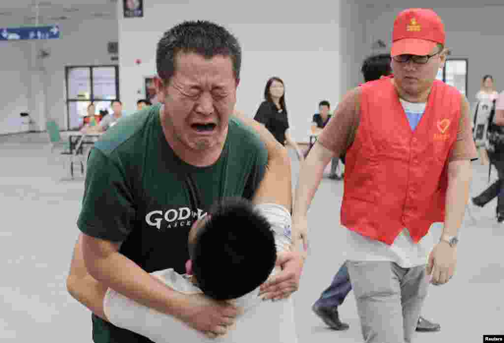 Family members cry at a caring centet for relatives of victims of a factory explosion, in Kunshan, Jiangsu province. China suffered its worst industrial accident in a year when an explosion killed at least 69 people and injured more than 120 at a factory that makes wheels for U.S. carmakers, including General Motors.