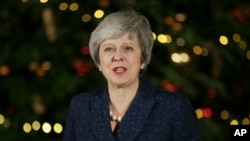British Prime Minister Theresa May makes a statement outside 10 Downing Street, in London, Dec. 12, 2018. British Prime Minister Theresa May survived a brush with political mortality Wednesday, winning a no-confidence vote of her Conservative lawmakers.