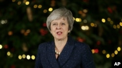 British Prime Minister Theresa May makes a statement outside 10 Downing Street, in London, Dec. 12, 2018. British Prime Minister Theresa May survived a brush with political mortality Wednesday, winning a no-confidence vote of her Conservative lawmakers.