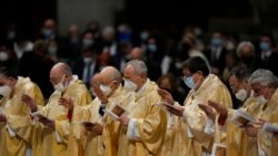 Cardinals attend the Christmas Eve Mass celebrated by Pope Francis, at St. Peter's Basilica, at the Vatican, Dec. 24, 2021.