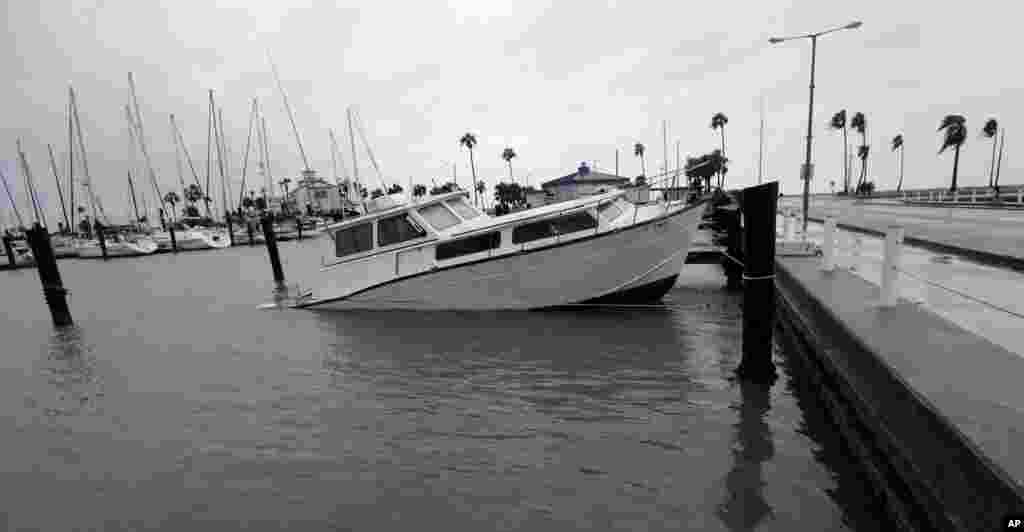 A fishing boat is left partial submerged after Hurricane Harvey swept through the area in Corpus Christi, Texas, Aug. 26, 2017.