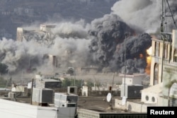 FILE - Smoke billows during an airstrike on the Republican Palace in Yemen's southwestern city of Taiz, April 17, 2015.