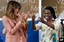 Godelieve Mukasarasi of Rwanda, holds up her award presented by first lady Melania Trump at the 2018 International Women of Courage awards, March 23, 2018, at the State Department in Washington.