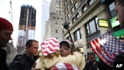 Dionne Layne, facing camera, hugs Mary Power as they react to the news of the death of Osama bin Laden, May 2, 2011 in New York. At left is the rising tower, 1 World Trade Center, also known as the Freedom Tower.