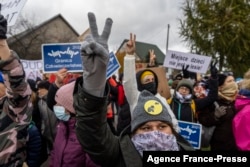 People take part in demonstration initiated by Polish mothers in front of the border guard office in Micholowo, Poland, to protest the deportation of migrants to Belarus, October 23, 2021.