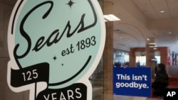A sign in the window at Sears promises that "This isn't goodbye," at the Livingston Mall in Livingston, N.J., Nov. 2, 2018. Sears is closing 80 more stores as it teeters on the brink of liquidation. The 130-year-old retailer set a deadline of Friday for b