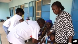 Health workers take a blood sample from a child in Gusau, northern Nigeria.