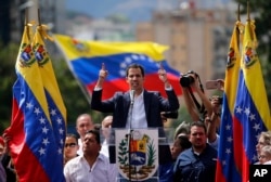 Juan Guaido, head of Venezuela's opposition-run congress, declares himself interim president of the nation until elections can be held during a rally demanding President Nicolas Maduro's resignation in Caracas, Venezuela, Jan. 23, 2019.