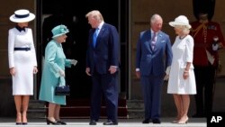Britain's Queen Elizabeth II greets President Donald Trump, center, and first lady Melania Trump, left, with Britain's Prince Charles and Camilla, Duchess of Cornwall during a ceremonial welcome in the garden of Buckingham Palace in London, June 3, 2019.