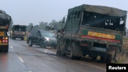 Soldiers stand beside military vehicles just outside Harare, Zimbabwe, Nov. 14, 2017. 