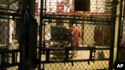 In this Feb. 2, 2016 photo, a detainee is seen in the communal area inside Camp 6 in the U.S. detention center at Guantanamo Bay, Cuba.