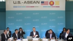 President Barack Obama, center, opens up his notebook before delivering remarks at the plenary session meeting of ASEAN, the 10-nation Association of Southeast Asian Nations, at the Annenberg Retreat at Sunnylands in Rancho Mirage, Calif., for Feb. 15, 20