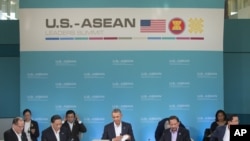 President Barack Obama, center, opens up his notebook before delivering remarks at the plenary session meeting of ASEAN, the 10-nation Association of Southeast Asian Nations, at the Annenberg Retreat at Sunnylands in Rancho Mirage, Calif., for Feb. 15, 20