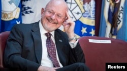FILE - Director of National Intelligence James R. Clapper listens during a retirement ceremony at the National Security Agency in Fort Meade, Maryland, March 28, 2014.