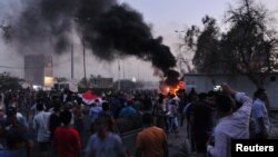 People gather during a protest near the main provincial government building because of the water pollution and poor services in Basra, Iraq, Aug. 31, 2018.