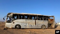 A bus damaged after a crash carrying Palestinian pilgrims en route to Saudi Arabia, on the outskirts of Maan, Jordan, Thursday, March 17, 2016. 