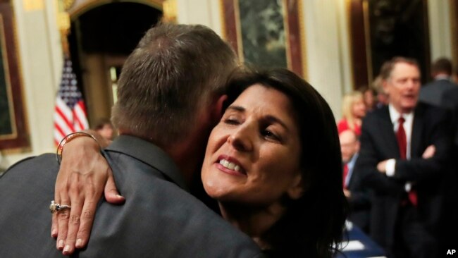 U.S. Ambassador to the United Nations Nikki Haley hugs Department of the Interior Secretary Ryan Zinke, as she arrives for the Interagency Task Force to Monitor and Combat Trafficking in Persons meeting in Washington, Oct. 11, 2018.