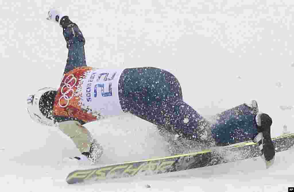 Japan's Taihei Kato breaks his left arm as he falls during the Nordic combined individual Gundersen large hill competition at the 2014 Winter Olympics, Feb. 18, 2014.