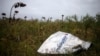 FILE - A piece of wreckage of the downed Malaysia Airlines flight MH17 is seen near the village of Hrabove, Donetsk region, eastern Ukraine, Sept. 9, 2014.