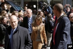 FILE - Fans photograph actress Lori Loughlin as she arrives at federal court in Boston, April 3, 2019, to face charges in a nationwide college admissions bribery scandal.
