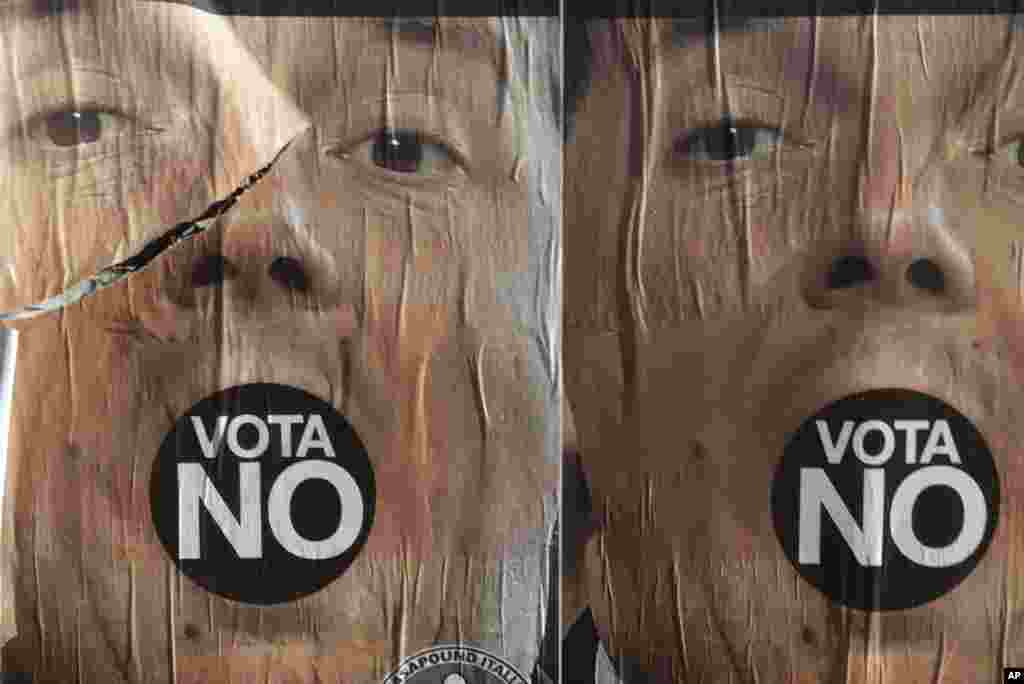 Anti-referendum posters showing Premier Matteo Renzi are seen in Rome, Italy, a day after the referendum vote. Voters rejected his proposed constitutional reforms, plunging Europe&#39;s fourth-largest economy into political and economic uncertainty.