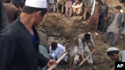 Afghans search for survivors buried after a massive landslide in a village in Badakhshan province, northeastern Afghanistan, May 2 2014 (photo via Homayoon Rahmani).