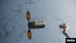 FILE - Orbital ATK's Cygnus cargo craft approaches the International Space Station on Dec. 9, 2015. 