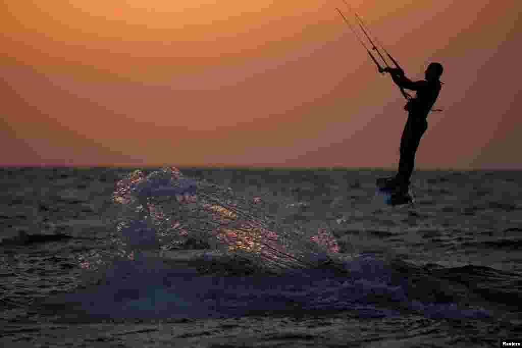 A man rides on his kitesurfing board in the Mediterranean sea in Ashkelon as restrictions following the coronavirus disease (COVID-19) ease around Israel, May 11, 2020.