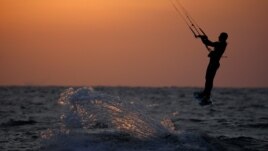 A man surfs with his kitesurfing board in the Mediterranean sea in Ashkelon as restrictions following the coronavirus disease (COVID-19) ease around Israel May 11, 2020.