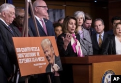 House Minority Leader Nancy Pelosi, D-Calif., center, speaks at a news conference, joined by, from left, Minority Whip Steny Hoyer, D-Md., and Rep. Joseph Crowley, D-N.Y., on the first morning of a government shutdown, at the Capitol in Washington, Jan. 20, 2018.