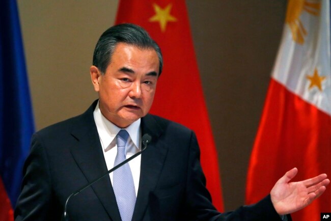 FILE - Chinese Foreign Minister Wang Yi gestures during a joint news conference with Philippine Foreign Affairs Secretary Alan Peter Cayetano in suburban Taguig city, east of Manila, Philippines, July 25, 2017.