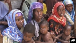 Mothers from southern Somalia hold their children at medical center in Mogadishu, Somalia, August 3, 2011.