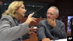 Germany's Finance Minister Wolfgang Schauble, right, talks with his Austrian counterpart Maria Fekter at the start of an Eurogroup meeting at the EU Council in Brussels, May 16, 2011