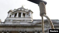 A replica hangman's noose is seen during a protest outside the Old Bailey courthouse in London February 26, 2014. Two British Muslim converts were sentenced on Wednesday for hacking soldier Lee Rigby to death in broad daylight on a London street in a grue