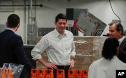 House Speaker Paul Ryan (C) tours a packaging facility in West Albany, Ohio, May 10, 2017.
