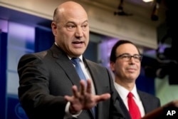 National Economic Director Gary Cohn, left, accompanied by Treasury Secretary Steve Mnuchin, speaks in the briefing room of the White House, in Washington, April 26, 2017, where they discussed President Donald Trump tax proposals.