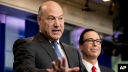 FILE - Chief White House economic adviser Gary Cohn, left, accompanied by Treasury Secretary Steve Mnuchin, speaks in the briefing room of the White House, in Washington, April 26, 2017. 