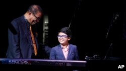 The jazz world has a new great musician. Joey Alexander is pictured here with legendary Herbie Hancock at the Apollo Theater, New York City, October 2014. Joey, by the way, is the child. (AP PHOTO)