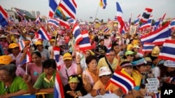 Yellow-shirted protesters wave national flags during a rally in Bangkok.