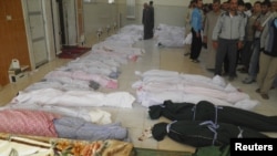 The bodies of people purportedly killed by Syrian government security forces are laid out in Houla near Homs May 26, 2012.