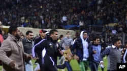 Football fans try to leave the stadium as chaos erupts at a soccer stadium in Port Said city, Egypt, February, 1, 2012. Seventy-three people were killed and at least 1,000 injured on Wednesday after a soccer pitch invasion in the Egyptian city of Port Sai