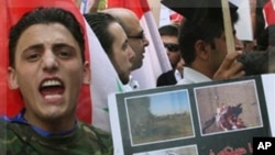A pro-Syrian regime protester, shouts slogans and holds up an Arabic placard which reads: "We saw your freedom in Iraq and Libya," as he protests in front the EU mission office, in Damascus, Syria, on Thursday Sept. 29, 2011. Supporters of President Basha
