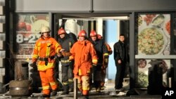 Rescuers work at the Maxima grocery store after its roof collapsed in Riga, Latvia, Nov. 21, 2013.